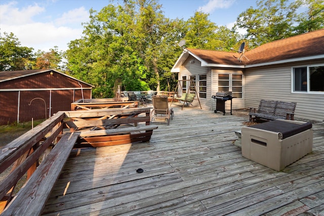 wooden deck with a grill