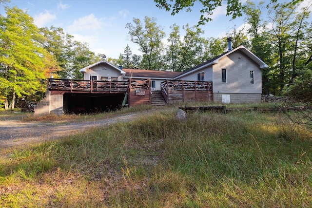 rear view of house with a wooden deck