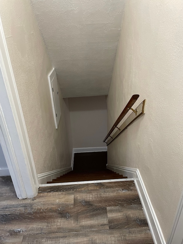 stairway featuring hardwood / wood-style floors