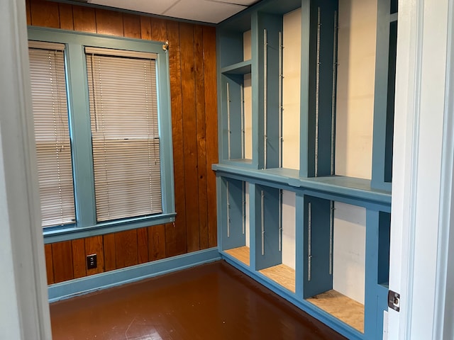 spare room featuring wood walls