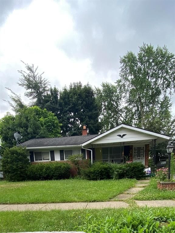 single story home featuring a front yard and covered porch