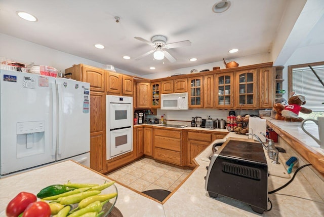 5563 Spring Creek Rd, Three Oaks, MI 49128 - kitchen with white appliances, brown cabinetry, light countertops, light tile patterned floors, and recessed lighting