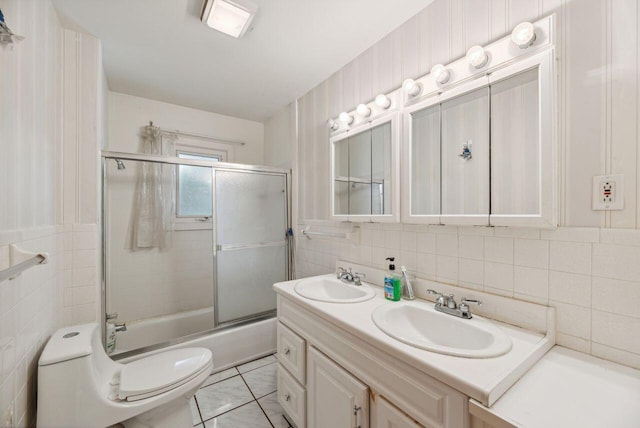 5563 Spring Creek Rd, Three Oaks, MI 49128 - bathroom featuring tile walls, double vanity, shower / bath combination with glass door, and tasteful backsplash