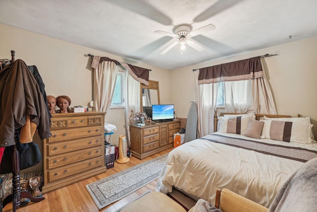 5563 Spring Creek Rd, Three Oaks, MI 49128 - bedroom with multiple windows, light wood finished floors, and a ceiling fan