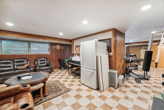5563 Spring Creek Rd, Three Oaks, MI 49128 - living area with radiator heating unit, wood walls, light flooring, and recessed lighting