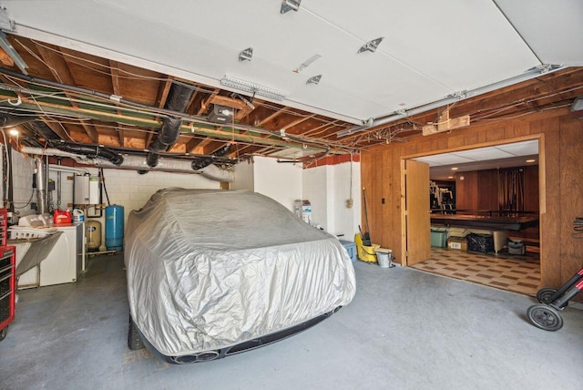 5563 Spring Creek Rd, Three Oaks, MI 49128 - garage with washer / dryer, wood walls, concrete block wall, and water heater