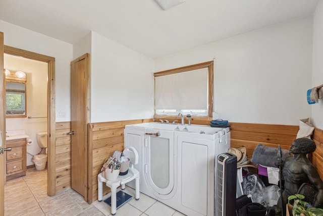5563 Spring Creek Rd, Three Oaks, MI 49128 - laundry area featuring light tile patterned floors and washer and clothes dryer