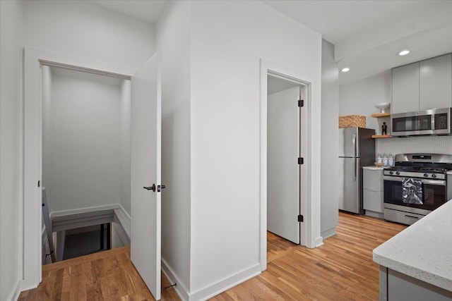 kitchen featuring stainless steel appliances and light hardwood / wood-style flooring