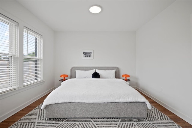 bedroom with dark hardwood / wood-style floors