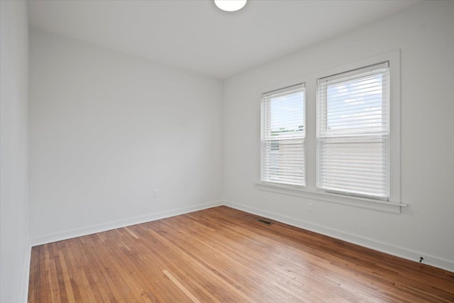 unfurnished room with light hardwood / wood-style floors