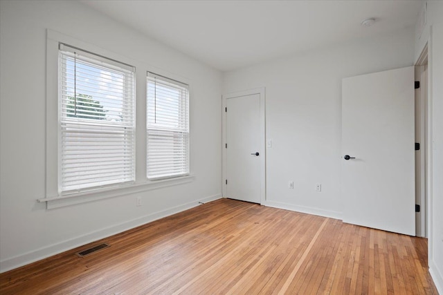 empty room with light hardwood / wood-style flooring