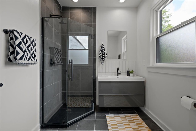 bathroom featuring tile patterned floors, vanity, and walk in shower