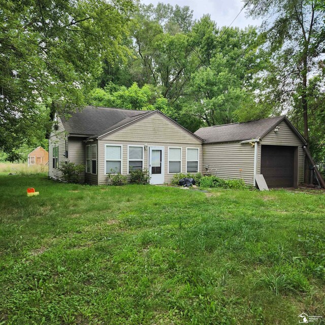 ranch-style home with a front lawn and a garage