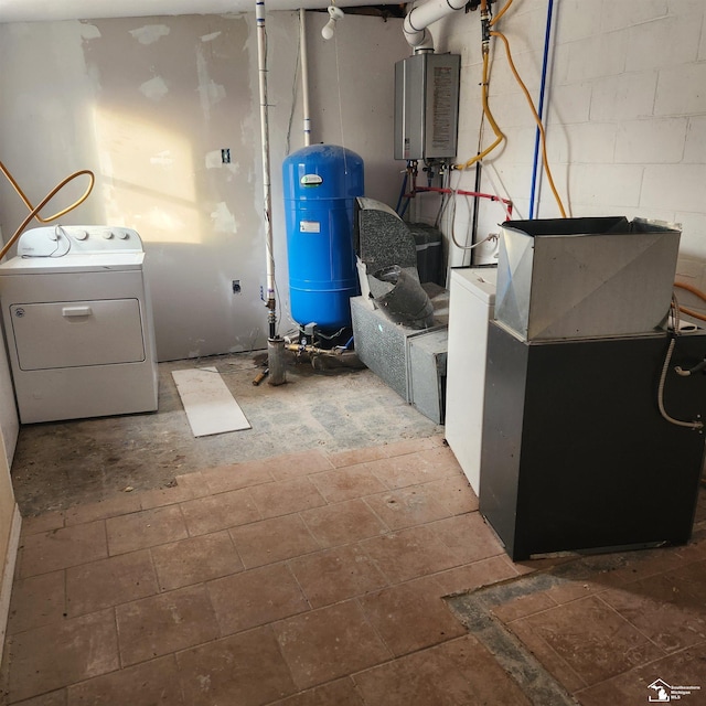 utility room featuring washer / dryer and tankless water heater