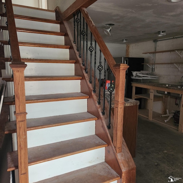 stairs with concrete flooring