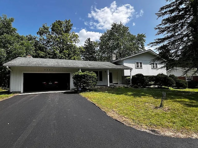 tri-level home with a garage and a front yard