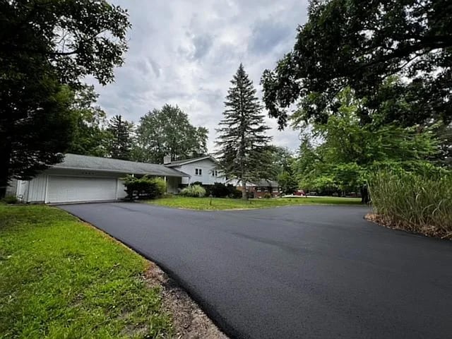 view of front of property with a garage and a front lawn