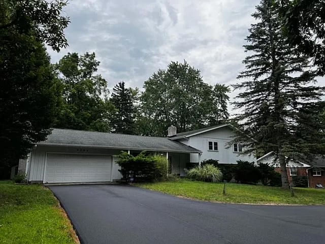 view of front of home with a front lawn and a garage