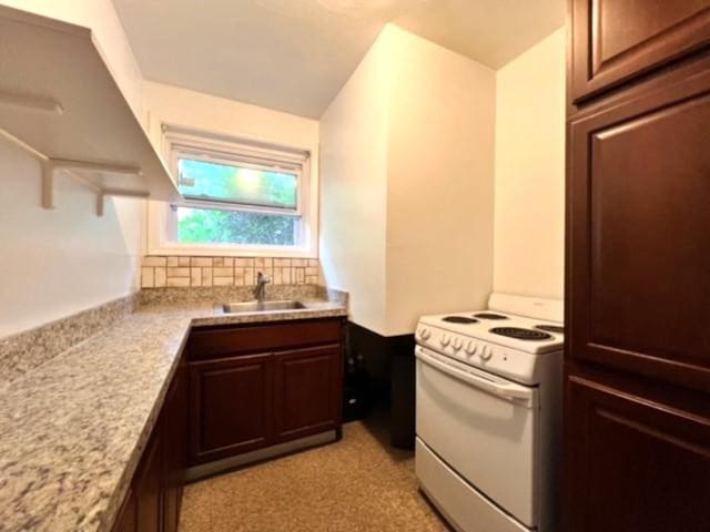 kitchen featuring decorative backsplash, dark brown cabinets, white range, and sink