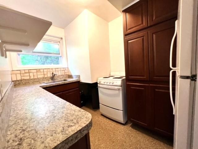 kitchen with decorative backsplash, white appliances, and sink