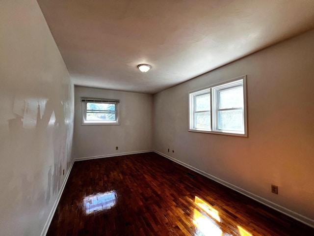 spare room featuring dark hardwood / wood-style floors