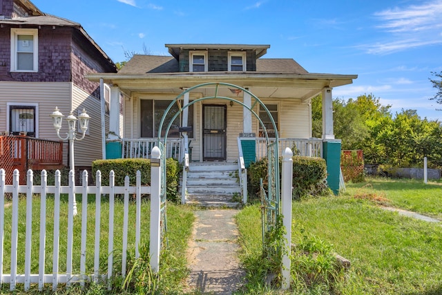 bungalow-style house with a porch and a front yard