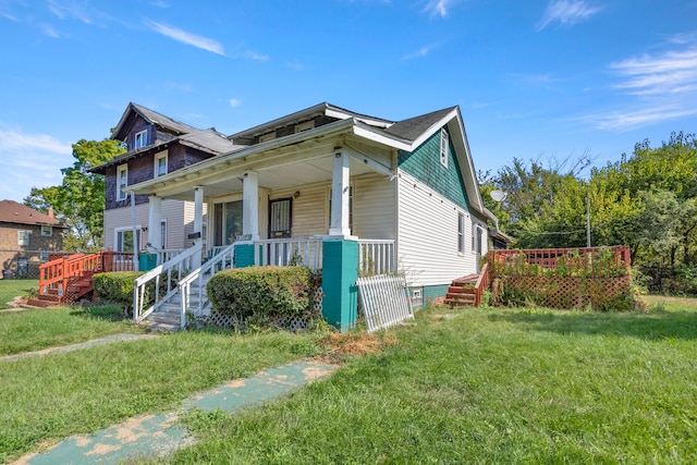 view of front of property featuring covered porch and a front yard