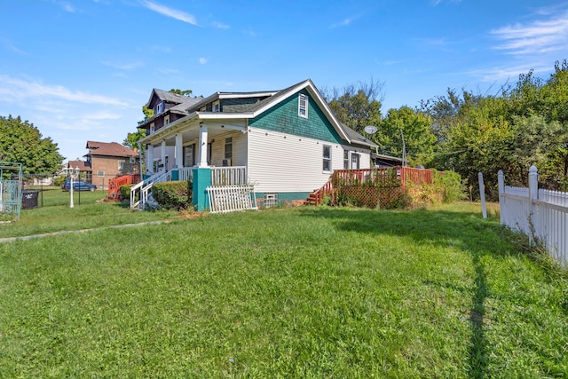 view of property exterior with a lawn and covered porch