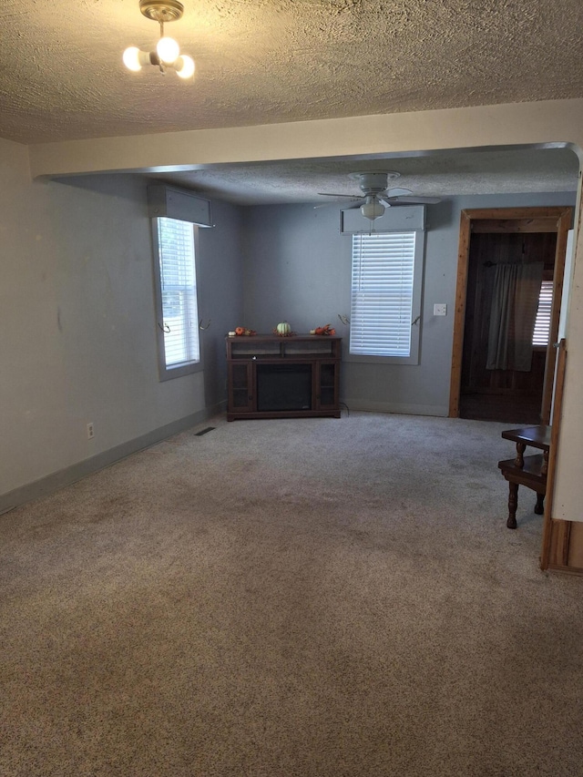 interior space featuring ceiling fan and a textured ceiling