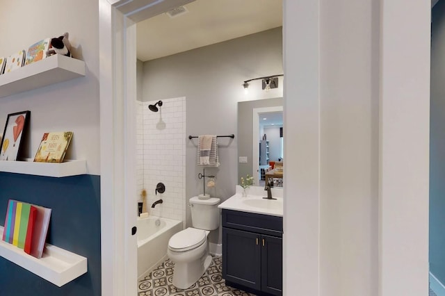 full bathroom featuring vanity, tiled shower / bath combo, and toilet