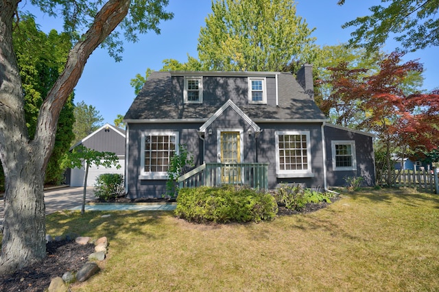 view of front of house featuring a front yard, an outbuilding, and a garage