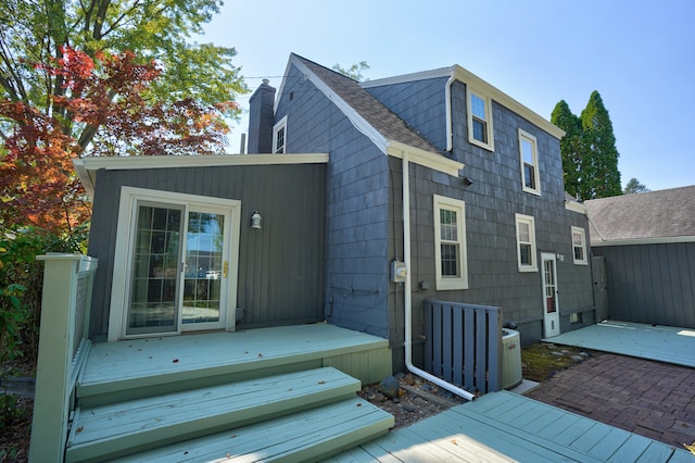 rear view of house featuring a deck