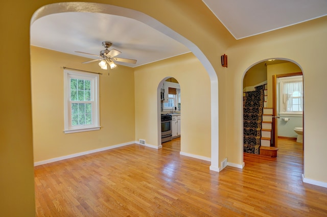 spare room featuring ceiling fan, sink, and light hardwood / wood-style floors