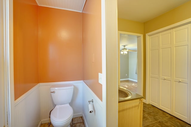 bathroom featuring tile patterned floors, ceiling fan, vanity, and toilet