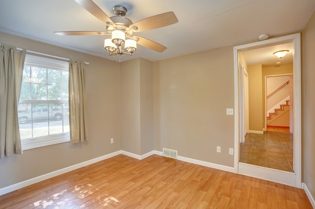 empty room with light hardwood / wood-style flooring and ceiling fan