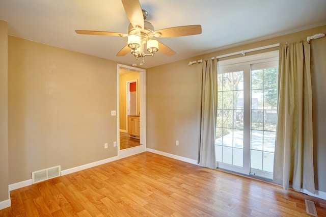 empty room featuring ceiling fan and light wood-type flooring