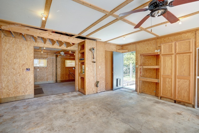 empty room with ceiling fan, a healthy amount of sunlight, and concrete floors