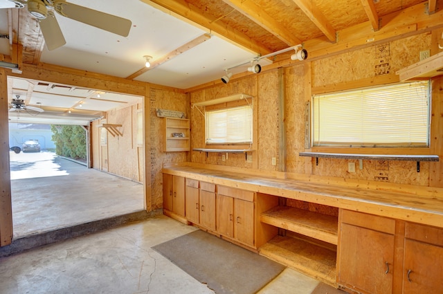 bathroom with concrete flooring, a workshop area, and ceiling fan