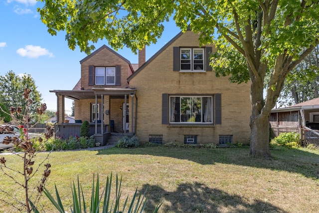 view of front of house with covered porch and a front yard