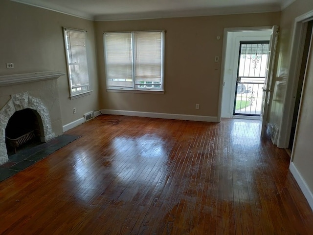 unfurnished living room with a fireplace, dark hardwood / wood-style flooring, and ornamental molding