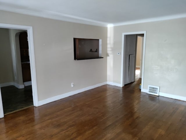 unfurnished living room with dark hardwood / wood-style floors