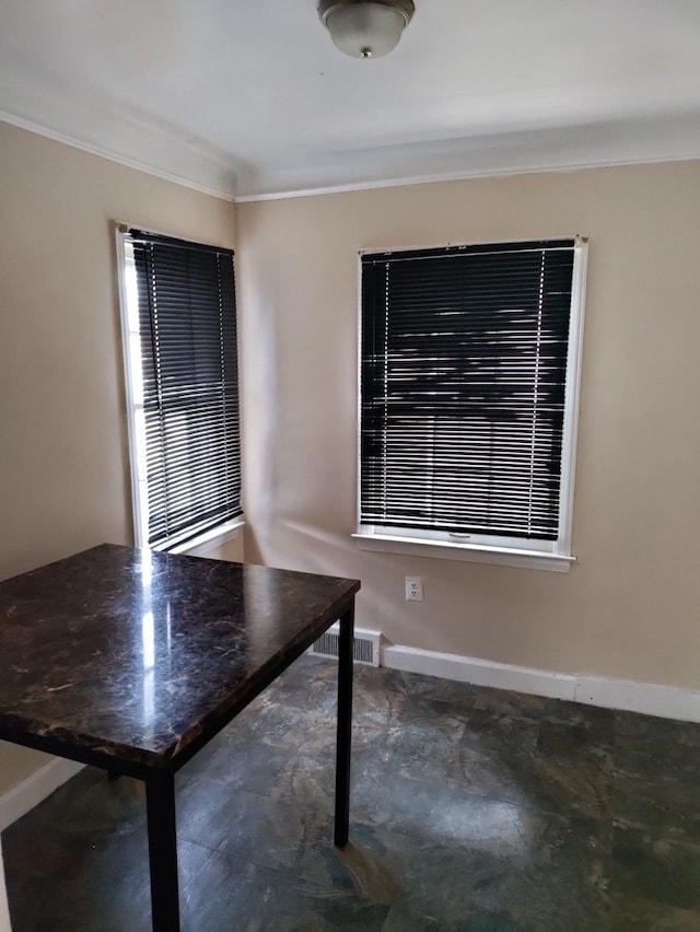 unfurnished dining area with crown molding