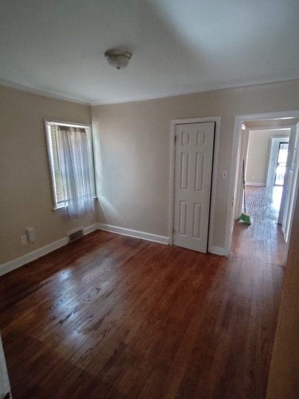 unfurnished room featuring dark hardwood / wood-style flooring