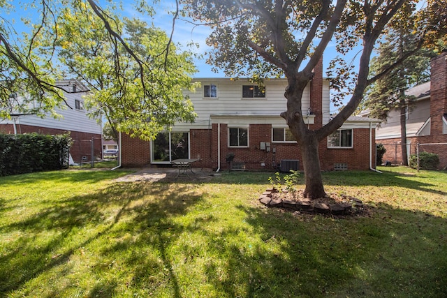 back of house with a lawn and central air condition unit