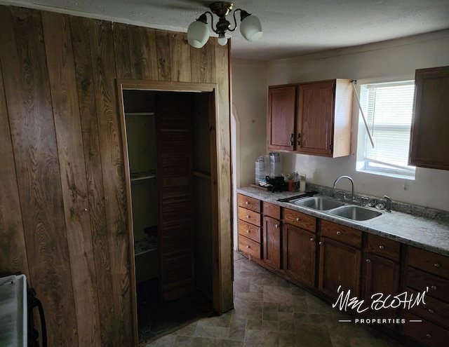 19136 130th Ave, Tustin, MI 49688 - kitchen with a sink, a ceiling fan, light countertops, and stone finish flooring