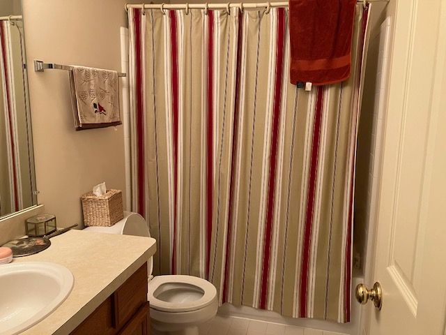 bathroom with tile patterned flooring, vanity, and toilet