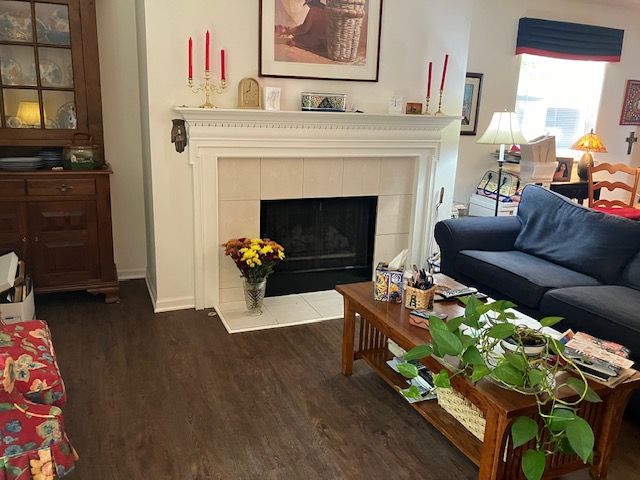 living room featuring dark hardwood / wood-style floors and a tile fireplace