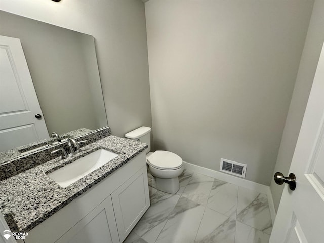 bathroom with vanity and toilet