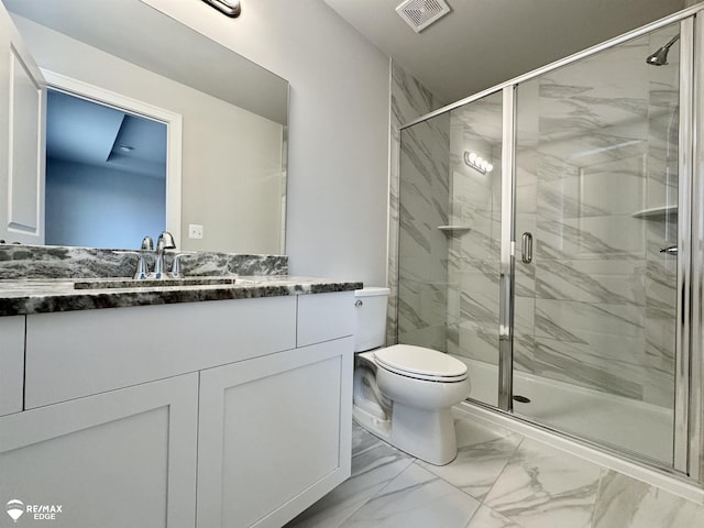 bathroom with a shower with door, vanity, and toilet