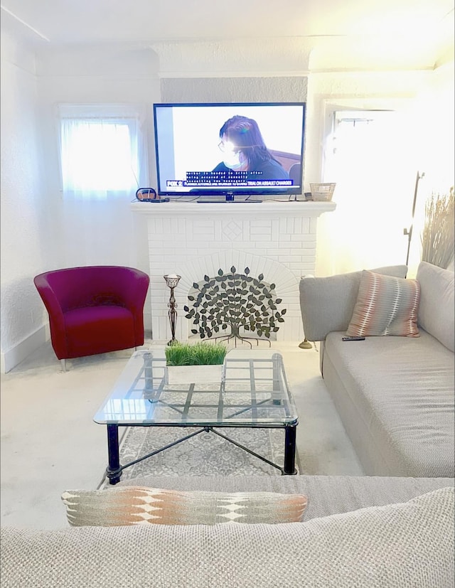 carpeted living room featuring a brick fireplace